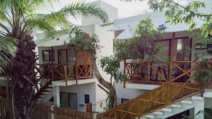 A multi-story building with a wooden staircase and balcony railings.