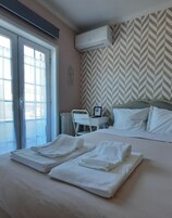 Une chambre d’hôtel équipée d’un lit, d’un bureau et d’un appareil de climatisation.