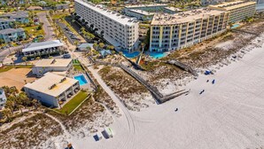 A coastal hotel with multiple buildings, a beach area, and a view of the sea. - Seacrest Beachfront 2BR | Angled Gulf View + Pools (Fort Walton Beach)