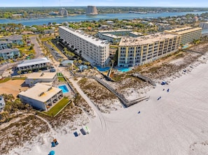 A coastal hotel with multiple buildings, a beach area, and a view of the sea. - Seacrest Beachfront 2BR | Angled Gulf View + Pools (Fort Walton Beach)