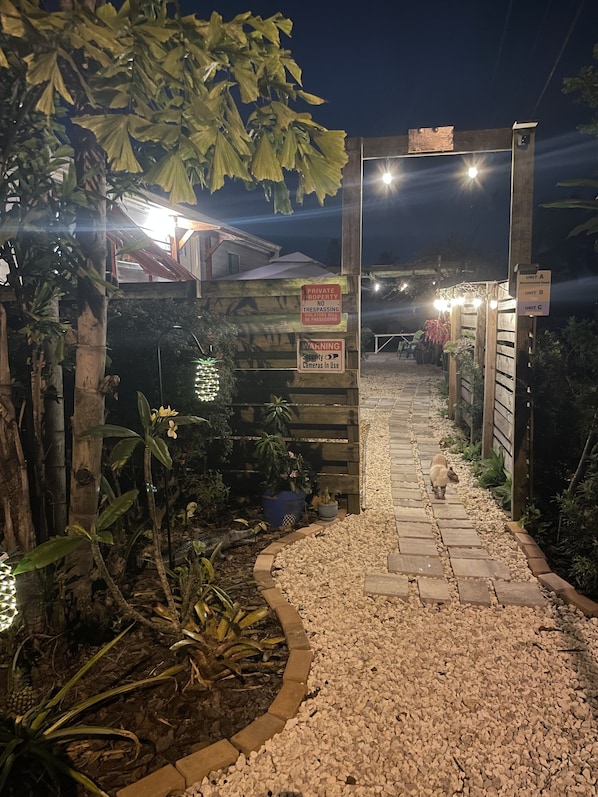 A gated entrance with signs indicating private property and security cameras.