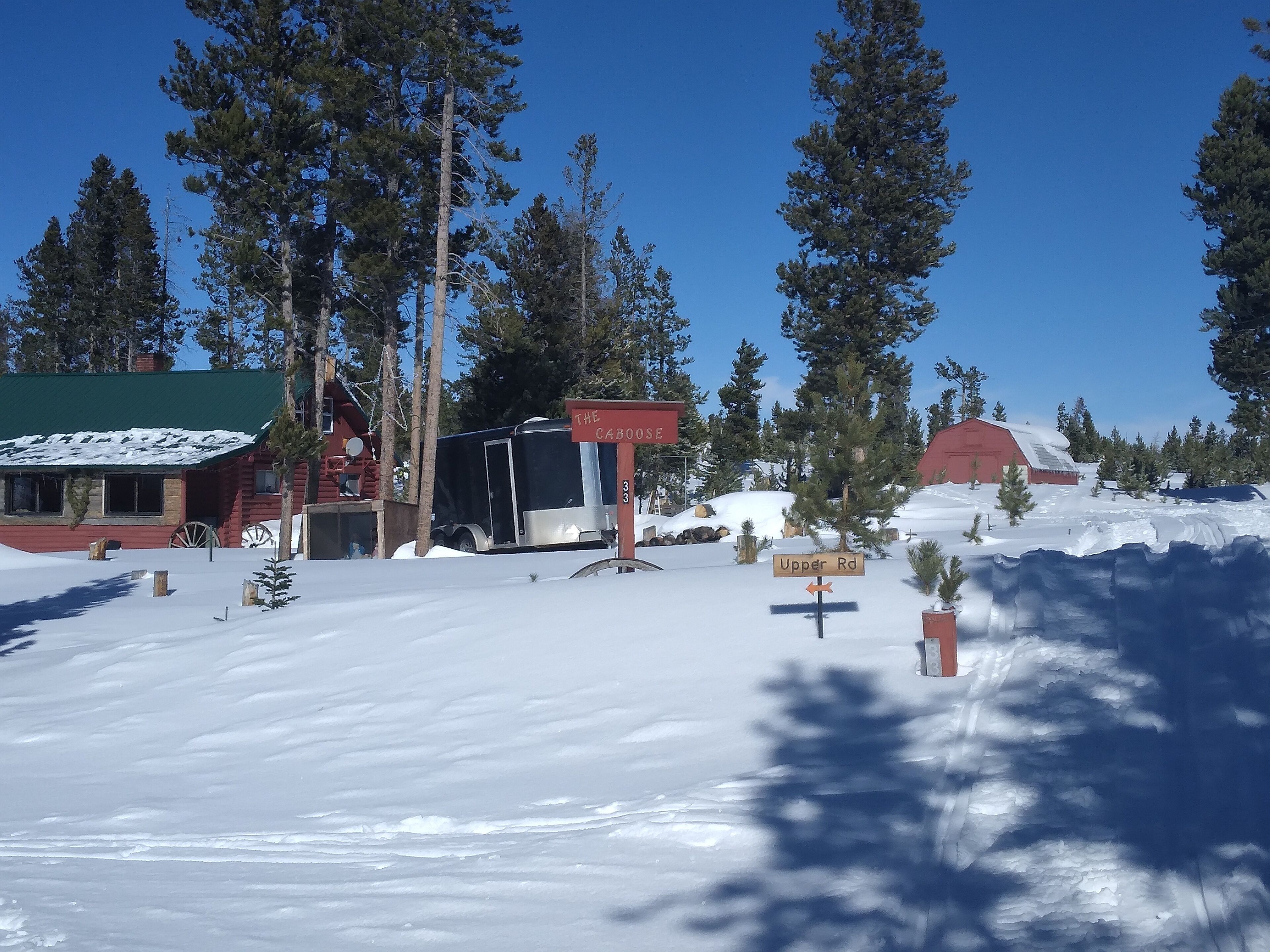 A cabin with a green roof and a sign reading "The Cabose."