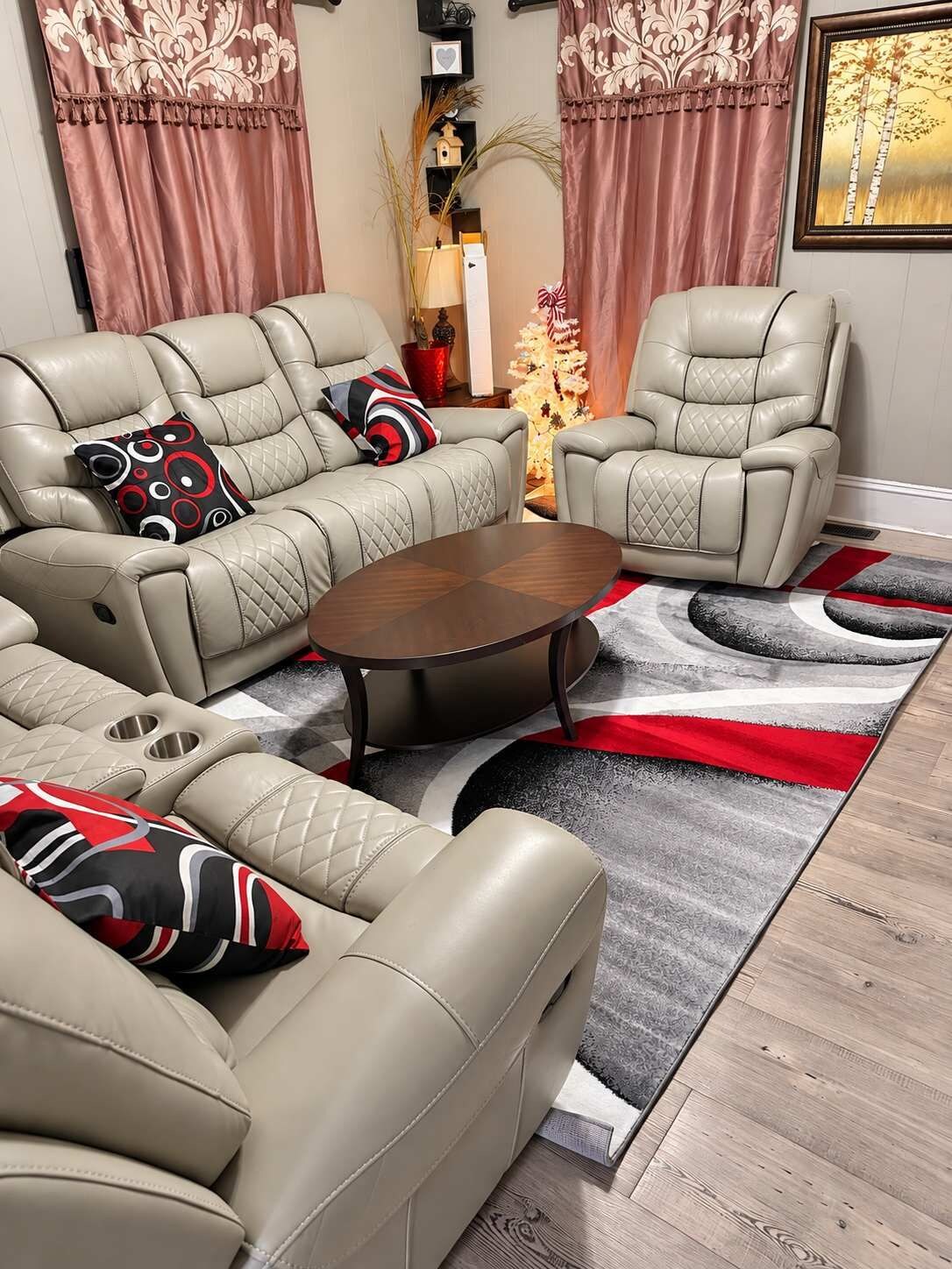 A living room with a sofa set, a coffee table, and a decorative rug.