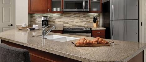 Een koelkast, kookgerei, borden en bestek