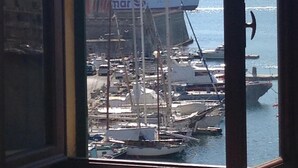 A view of a harbor with boats and a large ship docked. - The Rooms by the Sea (Portoferraio)
