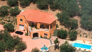 An aerial view of a large, orange building with a red roof, surrounded by trees and a swimming pool. - A corner of paradise for 10 guests in Drôme Provençale (Buis-les-Baronnies)