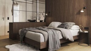 A modern bedroom with a wooden bed, a large mirror, and a small bedside table. - Premium Penthouse mit Sauna by Interhome (Haus)