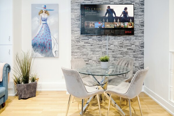 City Apartment | Living room | 70-inch TV with satellite channels