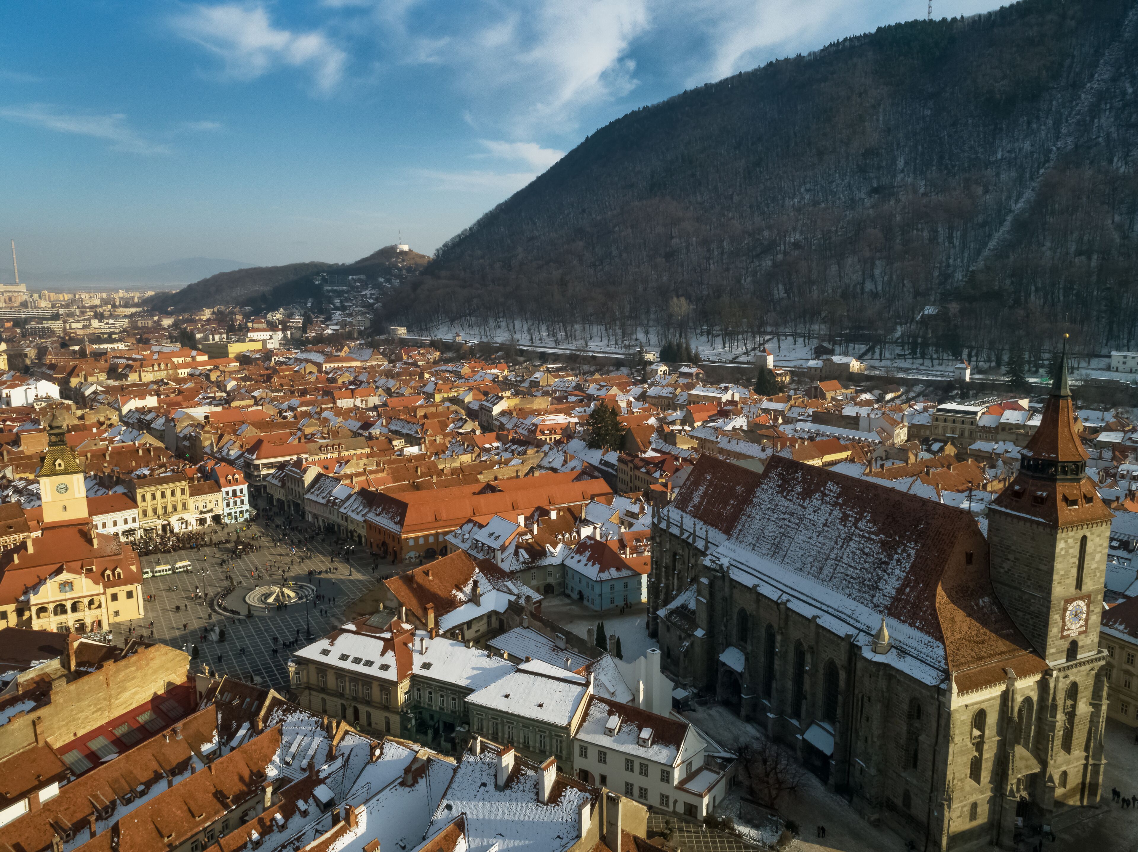 A historic town with a prominent church and a large square.
