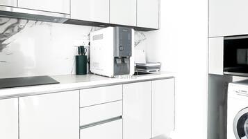A modern kitchen with white cabinetry, a Bosch water dispenser, and a Bosch washing machine.