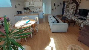A modern apartment with a kitchen, dining area, and living room.