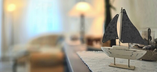 A model sailboat on a table with a blurred background.