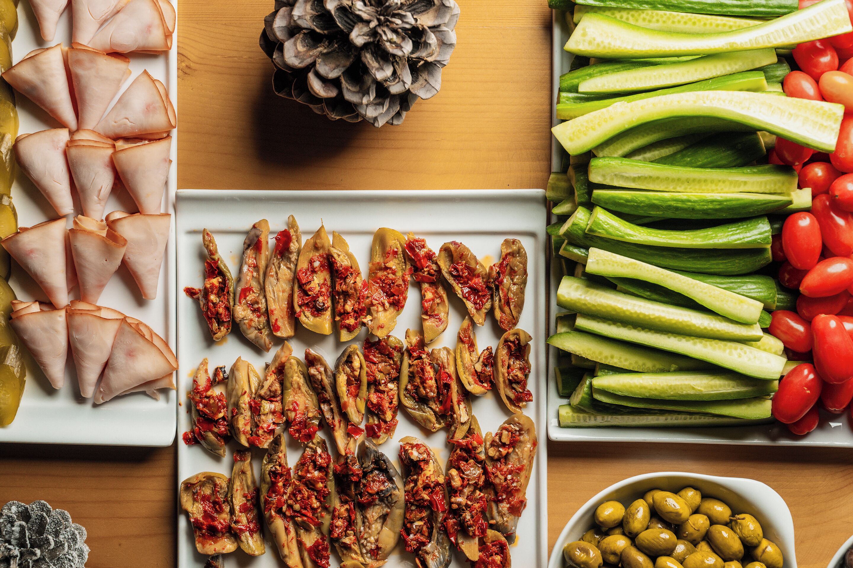 A table with various food items including stuffed vegetables and fresh produce.