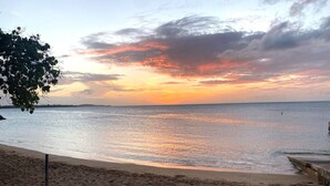 A beach with a clear sky and calm sea during sunset. - Luxury 5 Bedroom Home, 3 Minute Walk from the Beach (Dorado)