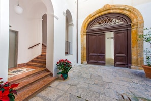 Traditional entrance with a stone staircase and ornate door.