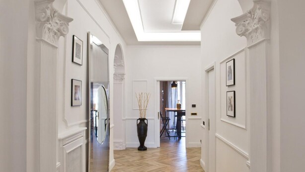 A hallway with a herringbone floor, white walls, and a skylight. - Eleganza nel Cuore di Napoli by Wonderful Italy (Naples)