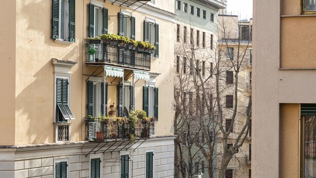 A building with multiple balconies, some with plants. - Carignano Design Apartment 7 by Wonderful Italy (Genoa)