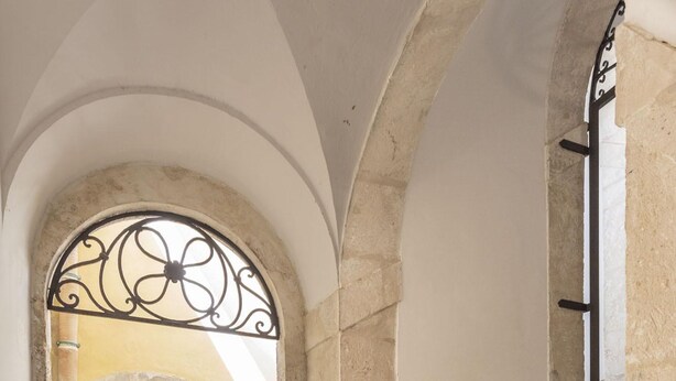 A stone staircase with a metal railing leading to an upper floor. - Salomone Apartment 15 With Terrace by Wonderful Italy (Syracuse)