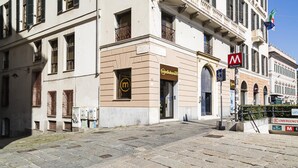 A building with a sign for 'Mediolanum' and a 'De Ferrari' sign. - La Dimora del Ducale by Wonderful Italy (Genoa)