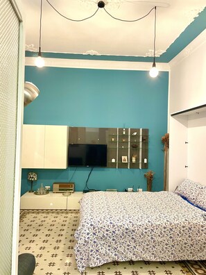 Relax in this inviting bedroom with a comfortable bed, flat-screen TV, and stylish decor.