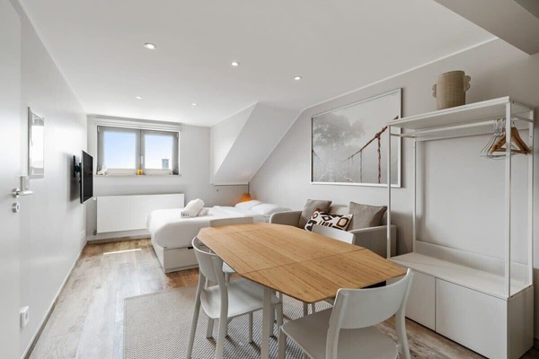 A delightful blend of comfort and functionality in this well-lit bedroom with dining space. Direct bookings: www.arcaproperties.lu