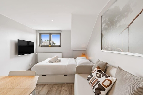 Bright and airy bedroom ambiance, with a convenient dining area for two. Direct bookings: www.arcaproperties.lu