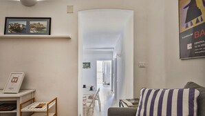A living room with a sofa, a bookshelf, and a framed picture on the wall. - A Pochi Passi da Piazza de Ferrari (Genoa)