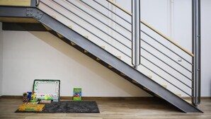 A staircase with a modern design, featuring metal railings and wooden steps. - Tribunali Family Apartment by Wonderful Italy (Naples)