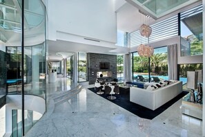 A modern interior with a glass facade, a pool, and a seating area.
