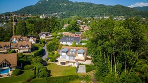 A residential area with houses, a mountain in the background, and a crane.
