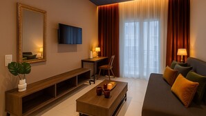 A modern living room with a sofa, a coffee table, a TV, a large mirror, and a window with curtains. - BLACK ONYX COMFORT SUITES (Thessaloniki)