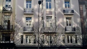 A multi-story building with a symmetrical facade, multiple balconies, and a central entrance. - BLACK ONYX COMFORT SUITES (Thessaloniki)