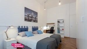 A modern bedroom with a large bed, bedside tables, a desk, and a bookshelf. - Torino 3 0 Sulla Via del Treno by Wonderful Italy (Turin)