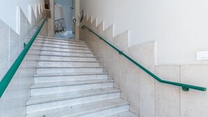 A staircase with marble steps and green handrails, leading to an interior space. - Casa Boccaccio by Wonderful Italy (Turin)