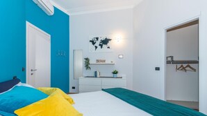 A bedroom with a bed, a dresser, a world map, and a 'DREAM' sign. - Casa Boccaccio by Wonderful Italy (Turin)