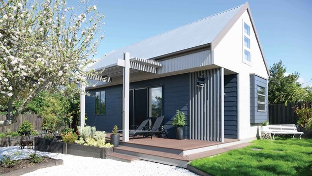 A modern two-story house with a covered patio, a small garden, and a wooden fence. - Daydream Cottage (Daylesford)