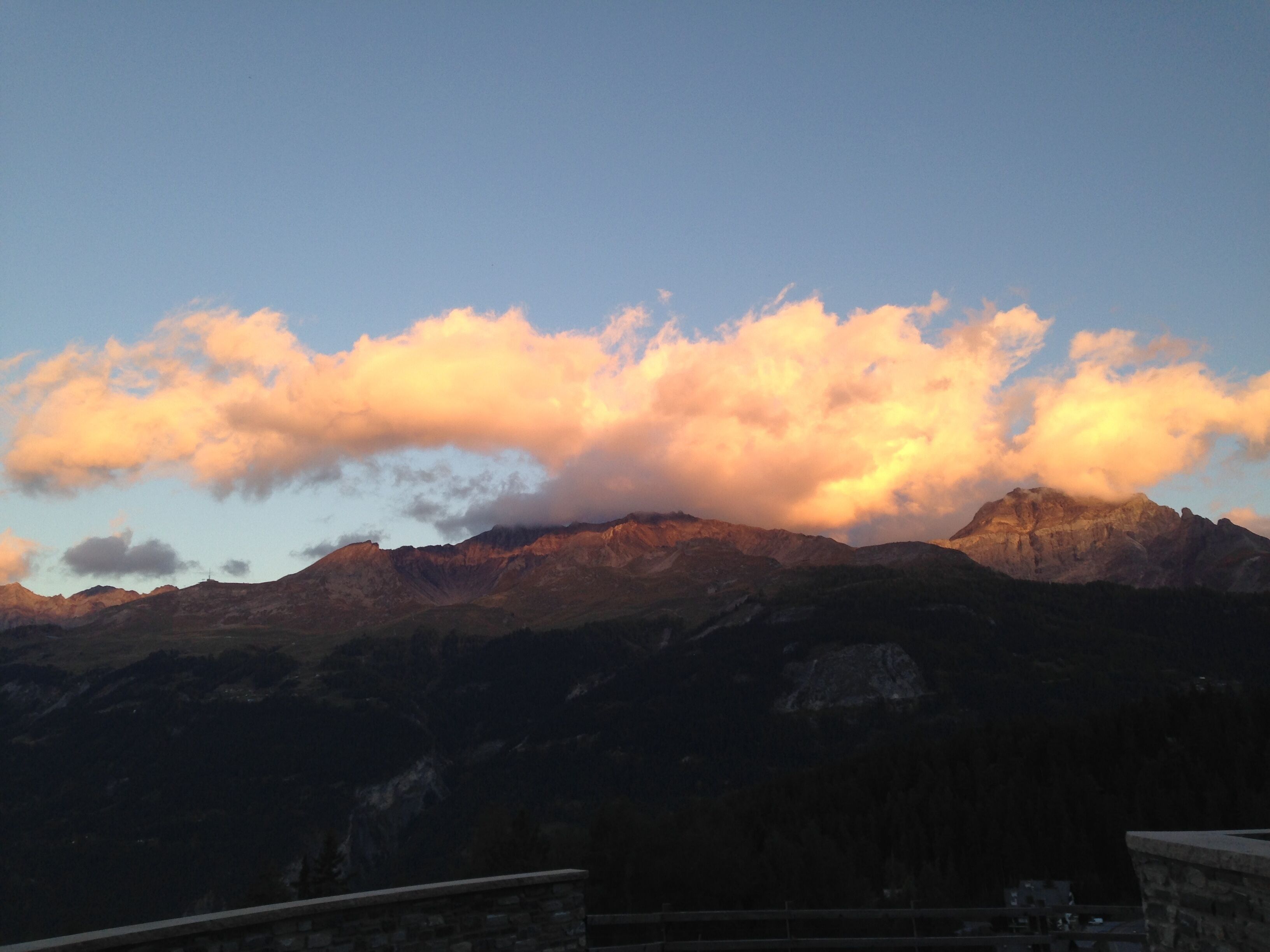 A mountain range with a clear sky and clouds.