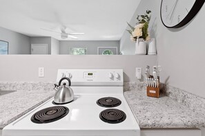 Fridge, coffee/tea maker, cookware/dishes/utensils, spices