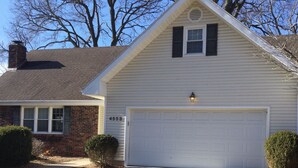 A single-story house with a white garage door, a brick section on the left, and a clear driveway. - 5 Star Location (Springfield)