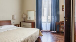 A hotel room with a bed, a dresser, a chair, a desk, a mirror, and a door. - Grimaldi 8 Apartment by Wonderful Italy (Catania)