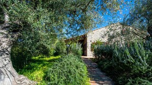 A stone building with a stone pathway leading to a wooden door. - Villetta Rosamarina by Wonderful Italy (Cefalù)