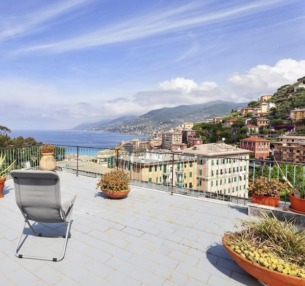 Enjoy breathtaking views of the sea and the charming coastal town from this outdoor space.