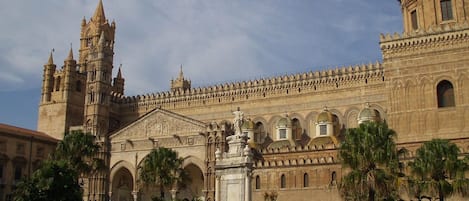 A historic building with intricate architecture, featuring a prominent dome and multiple towers.