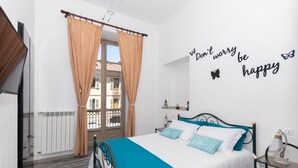 A bedroom with a bed, curtains, a wall with a motivational quote, and a window. - Ai Piedi Della Collina by Wonderful Italy (Turin)