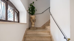 A staircase with a potted plant on the landing.