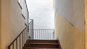 A staircase with metal railings leading to a landing.
