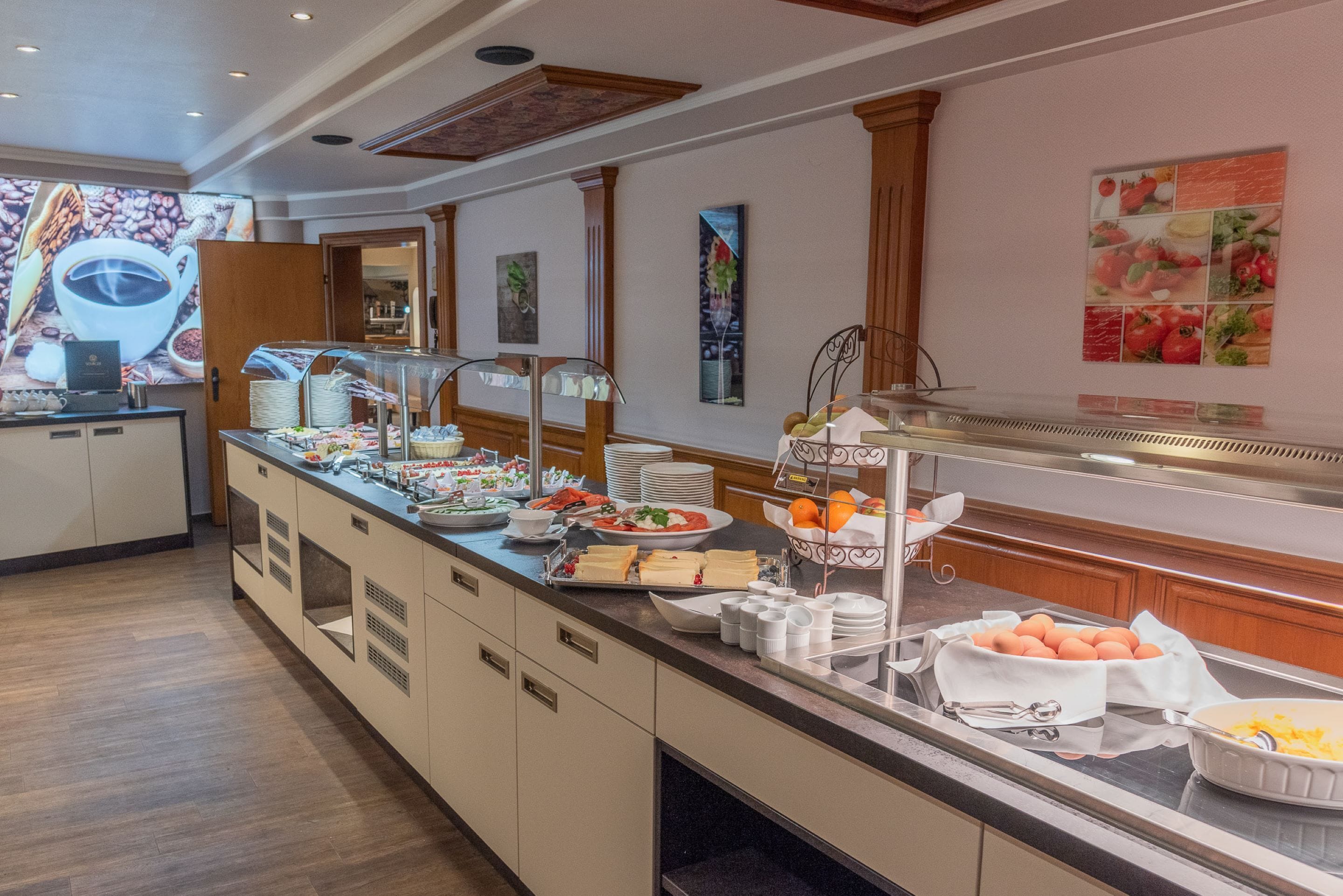 A buffet setup with various food items and a coffee station.