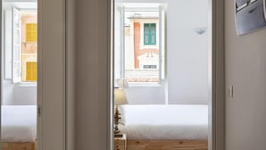 A bedroom with a bed, a window, and a view of buildings outside. - Cozy Holiday Home in Camogli (Camogli)