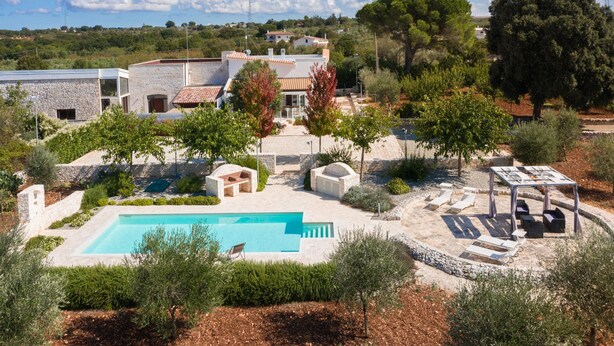 A pool area with a rectangular pool, lounge chairs, and a pergola. - Villa Marangi con Piscina (Taurisano)