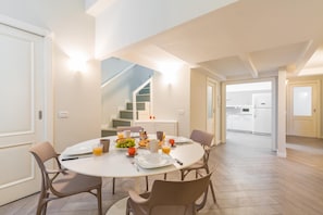 Enjoy meals in this stylish dining area with a round table for four, surrounded by a clean and minimalist design.